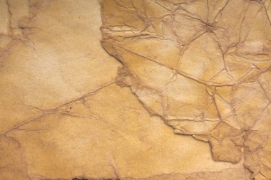 Aged paper sheet. Blank old background with dust and dirty stains. Vintage and antique art concept. Poster mockup. Detailed closeup studio shot. Front view. Toned