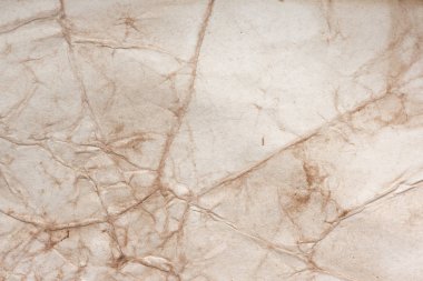 Aged paper sheet. Blank old background with dust and dirty stains. Vintage and antique art concept. Poster mockup. Detailed closeup studio shot. Front view. Toned