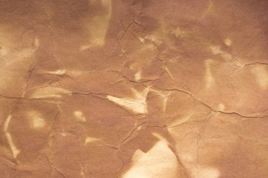 Aged paper sheet. Blank old background with dust and dirty stains. Vintage and antique art concept. Poster mockup. Detailed closeup studio shot. Front view. Toned
