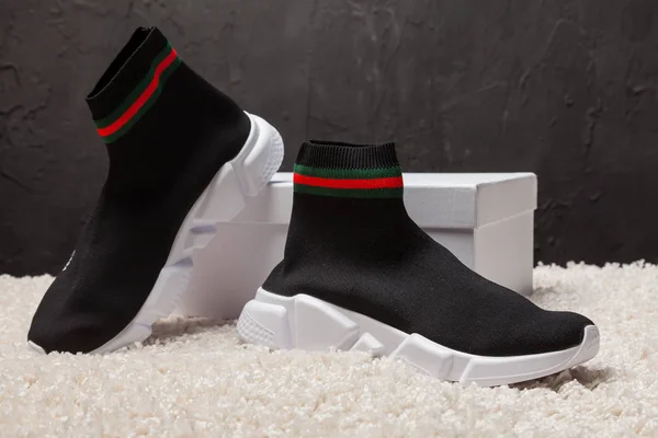 Yeni güzel renkli ve güzel Balenciaga Gucci koşu ayakkabıları, spor ayakkabıları, spor ayakkabıları, spor ayakkabıları soyut arkaplanda marka kutusu olan logoyu gösteriyor. Spor ve günlük ayakkabı konsepti. Kyiv, Ukrayna-11 Nisan 2018