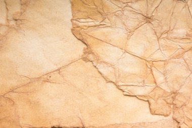 Aged paper sheet. Blank old background with dust and dirty stains. Vintage and antique art concept. Poster mockup. Detailed closeup studio shot. Front view. Toned