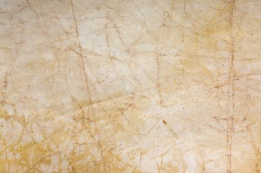 Aged paper sheet. Blank old background with dust and dirty stains. Vintage and antique art concept. Poster mockup. Detailed closeup studio shot. Front view. Toned