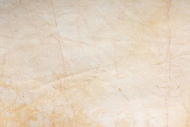 Aged paper sheet. Blank old background with dust and dirty stains. Vintage and antique art concept. Poster mockup. Detailed closeup studio shot. Front view. Toned