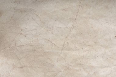 Aged paper sheet. Blank old background with dust and dirty stains. Vintage and antique art concept. Poster mockup. Detailed closeup studio shot. Front view. Toned