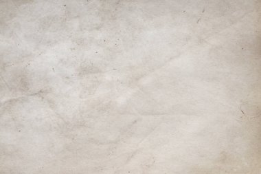 Aged paper sheet. Blank old background with dust and dirty stains. Vintage and antique art concept. Poster mockup. Detailed closeup studio shot. Front view. Toned