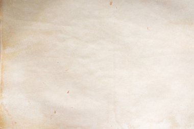 Aged paper sheet. Blank old background with dust and dirty stains. Vintage and antique art concept. Poster mockup. Detailed closeup studio shot. Front view. Toned