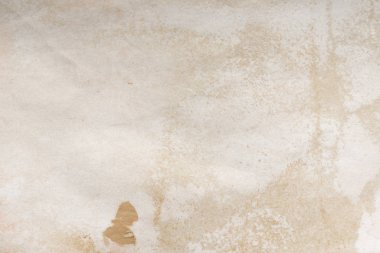 Aged paper sheet. Blank old background with dust and dirty stains. Vintage and antique art concept. Poster mockup. Detailed closeup studio shot. Front view. Toned