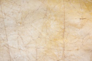 Aged paper sheet. Blank old background with dust and dirty stains. Vintage and antique art concept. Poster mockup. Detailed closeup studio shot. Front view. Toned