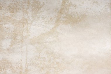 Aged paper sheet. Blank old background with dust and dirty stains. Vintage and antique art concept. Poster mockup. Detailed closeup studio shot. Front view. Toned