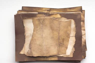 Aged paper sheet. Blank old background with dust and dirty stains. Vintage and antique art concept. Poster mockup. Detailed closeup studio shot. Front view. Toned
