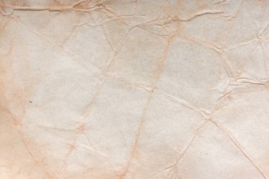 Aged paper sheet. Blank old background with dust and dirty stains. Vintage and antique art concept. Poster mockup. Detailed closeup studio shot. Front view. Toned