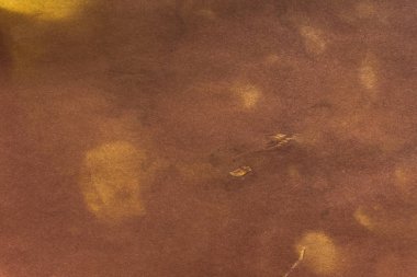 Aged paper sheet. Blank old background with dust and dirty stains. Vintage and antique art concept. Poster mockup. Detailed closeup studio shot. Front view. Toned