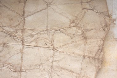 Aged paper sheet. Blank old background with dust and dirty stains. Vintage and antique art concept. Poster mockup. Detailed closeup studio shot. Front view. Toned