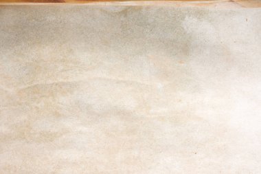 Aged paper sheet. Blank old background with dust and dirty stains. Vintage and antique art concept. Poster mockup. Detailed closeup studio shot. Front view. Toned