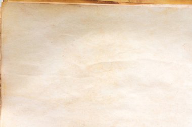 Aged paper sheet. Blank old background with dust and dirty stains. Vintage and antique art concept. Poster mockup. Detailed closeup studio shot. Front view. Toned