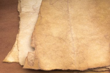 Aged paper sheet. Blank old background with dust and dirty stains. Vintage and antique art concept. Poster mockup. Detailed closeup studio shot. Front view. Toned