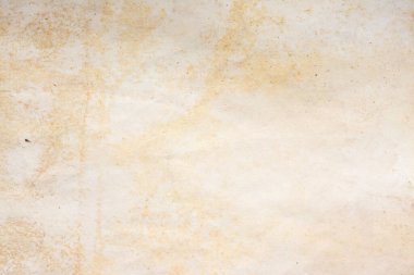 Aged paper sheet. Blank old background with dust and dirty stains. Vintage and antique art concept. Poster mockup. Detailed closeup studio shot. Front view. Toned