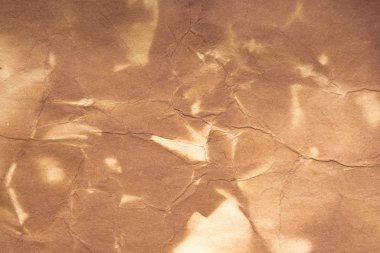 Aged paper sheet. Blank old background with dust and dirty stains. Vintage and antique art concept. Poster mockup. Detailed closeup studio shot. Front view. Toned