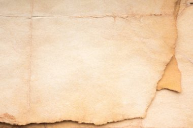 Aged paper sheet. Blank old background with dust and dirty stains. Vintage and antique art concept. Poster mockup. Detailed closeup studio shot. Front view. Toned