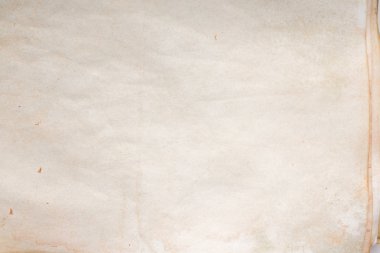 Aged paper sheet. Blank old background with dust and dirty stains. Vintage and antique art concept. Poster mockup. Detailed closeup studio shot. Front view. Toned
