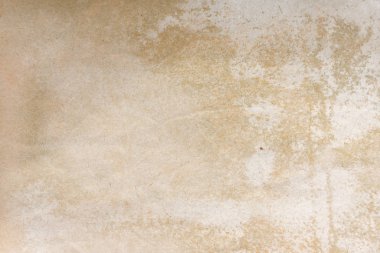 Aged paper sheet. Blank old background with dust and dirty stains. Vintage and antique art concept. Poster mockup. Detailed closeup studio shot. Front view. Toned