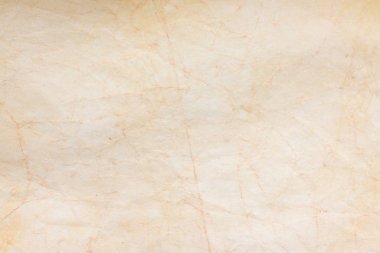 Aged paper sheet. Blank old background with dust and dirty stains. Vintage and antique art concept. Poster mockup. Detailed closeup studio shot. Front view. Toned