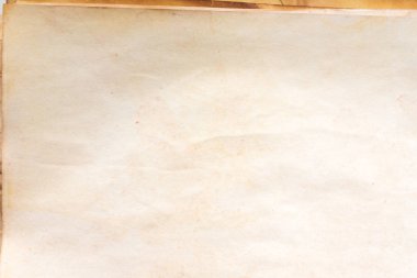 Aged paper sheet. Blank old background with dust and dirty stains. Vintage and antique art concept. Poster mockup. Detailed closeup studio shot. Front view. Toned