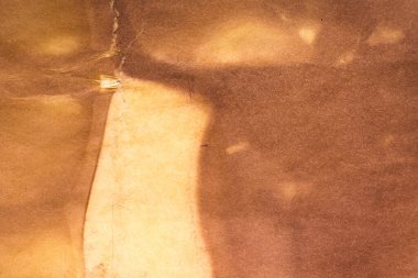 Aged paper sheet. Blank old background with dust and dirty stains. Vintage and antique art concept. Poster mockup. Detailed closeup studio shot. Front view. Toned