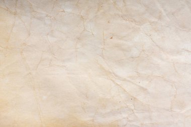 Aged paper sheet. Blank old background with dust and dirty stains. Vintage and antique art concept. Poster mockup. Detailed closeup studio shot. Front view. Toned