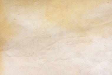 Aged paper sheet. Blank old background with dust and dirty stains. Vintage and antique art concept. Poster mockup. Detailed closeup studio shot. Front view. Toned