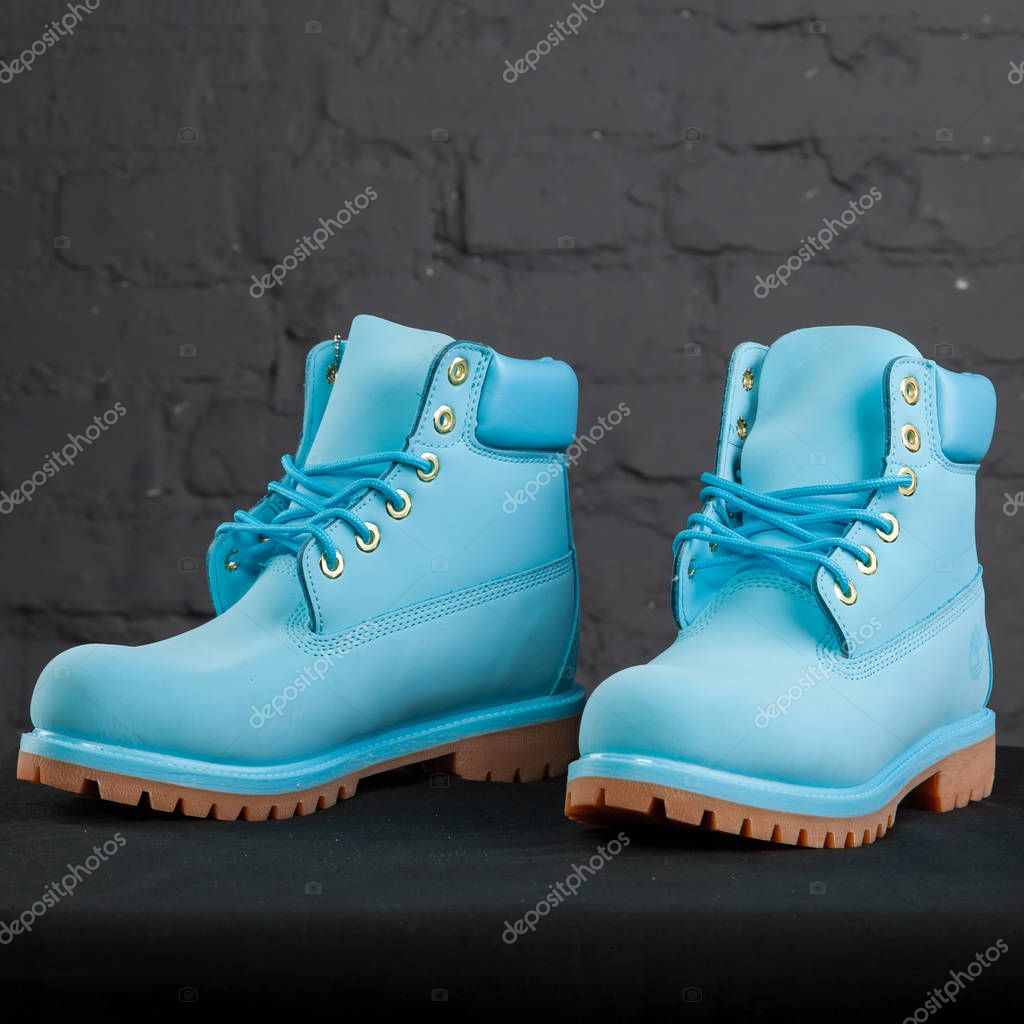 New beautiful colorful and nice Timberland tracking shoes, sneakers, trainers shows logo with a brand box on abstract background. Sport and casual footwear concept. Kyiv, Ukraine-November 24, 2017