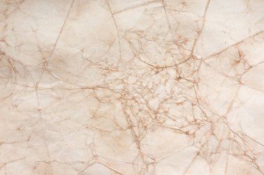 Aged paper sheet. Blank old background with dust and dirty stains. Vintage and antique art concept. Poster mockup. Detailed closeup studio shot. Front view. Toned