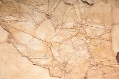 Aged paper sheet. Blank old background with dust and dirty stains. Vintage and antique art concept. Poster mockup. Detailed closeup studio shot. Front view. Toned