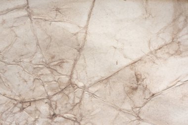 Aged paper sheet. Blank old background with dust and dirty stains. Vintage and antique art concept. Poster mockup. Detailed closeup studio shot. Front view. Toned