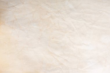 Aged paper sheet. Blank old background with dust and dirty stains. Vintage and antique art concept. Poster mockup. Detailed closeup studio shot. Front view. Toned