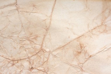 Aged paper sheet. Blank old background with dust and dirty stains. Vintage and antique art concept. Poster mockup. Detailed closeup studio shot. Front view. Toned