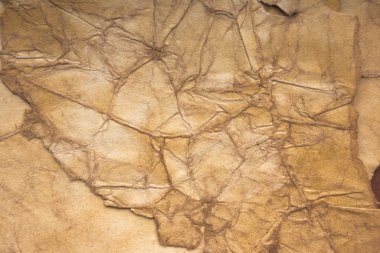 Aged paper sheet. Blank old background with dust and dirty stains. Vintage and antique art concept. Poster mockup. Detailed closeup studio shot. Front view. Toned