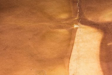 Aged paper sheet. Blank old background with dust and dirty stains. Vintage and antique art concept. Poster mockup. Detailed closeup studio shot. Front view. Toned