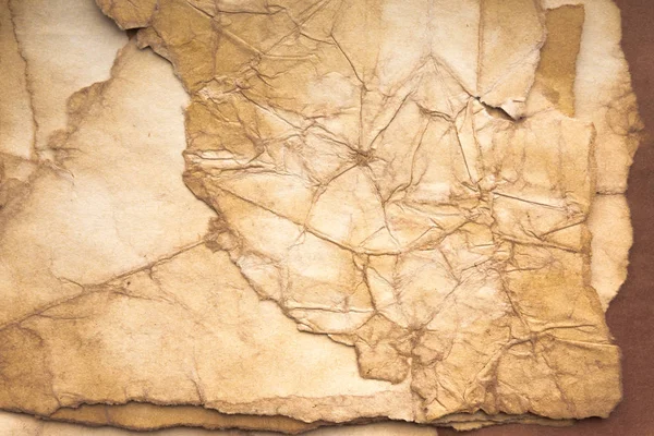 Aged paper sheet. Blank old background with dust and dirty stains. Vintage and antique art concept. Poster mockup. Detailed closeup studio shot. Front view. Toned