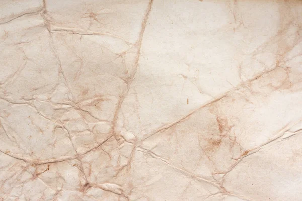 Aged paper sheet. Blank old background with dust and dirty stains. Vintage and antique art concept. Poster mockup. Detailed closeup studio shot. Front view. Toned