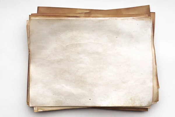 Aged paper sheet. Blank old background with dust and dirty stains. Vintage and antique art concept. Poster mockup. Detailed closeup studio shot. Front view. Toned