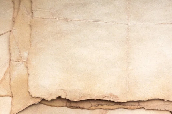 Aged paper sheet. Blank old background with dust and dirty stains. Vintage and antique art concept. Poster mockup. Detailed closeup studio shot. Front view. Toned