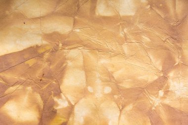 Aged paper sheet. Blank old background with dust and dirty stains. Vintage and antique art concept. Poster mockup. Detailed closeup studio shot. Front view. Toned