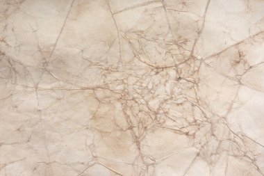 Aged paper sheet. Blank old background with dust and dirty stains. Vintage and antique art concept. Poster mockup. Detailed closeup studio shot. Front view. Toned