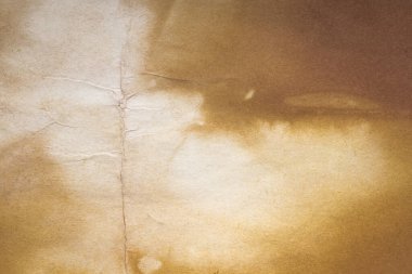 Aged paper sheet. Blank old background with dust and dirty stains. Vintage and antique art concept. Poster mockup. Detailed closeup studio shot. Front view. Toned