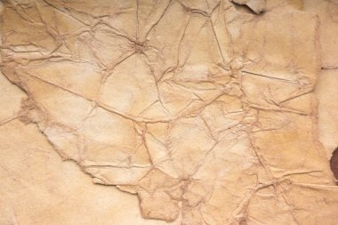 Aged paper sheet. Blank old background with dust and dirty stains. Vintage and antique art concept. Poster mockup. Detailed closeup studio shot. Front view. Toned