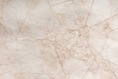 Aged paper sheet. Blank old background with dust and dirty stains. Vintage and antique art concept. Poster mockup. Detailed closeup studio shot. Front view. Toned