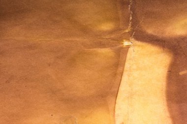 Aged paper sheet. Blank old background with dust and dirty stains. Vintage and antique art concept. Poster mockup. Detailed closeup studio shot. Front view. Toned