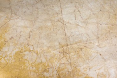 Aged paper sheet. Blank old background with dust and dirty stains. Vintage and antique art concept. Poster mockup. Detailed closeup studio shot. Front view. Toned