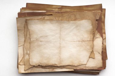 Aged paper sheet. Blank old background with dust and dirty stains. Vintage and antique art concept. Poster mockup. Detailed closeup studio shot. Front view. Toned